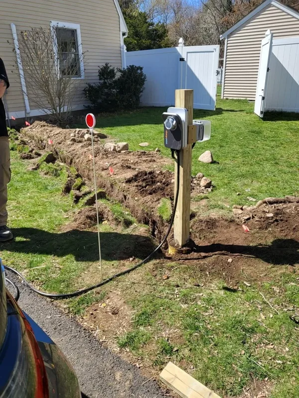 EV charging station circuit being trenched in a yard